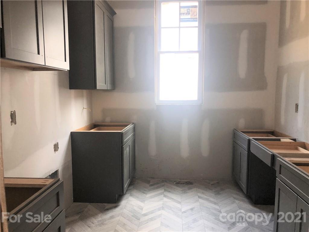5520 Closeburn Road Charlotte, NC 28210 - Photo 6 of 32 a room with cabinets and window