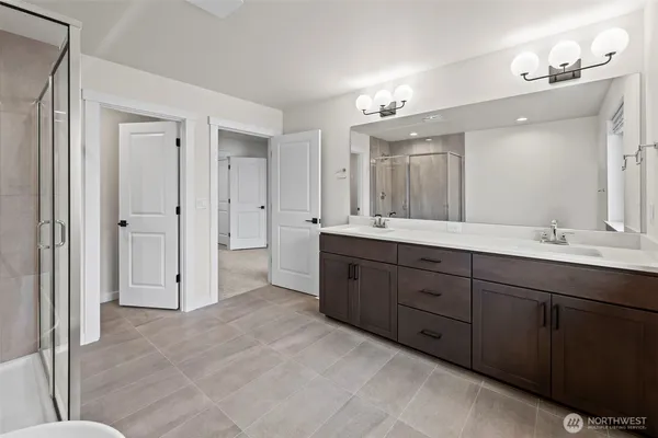 a spacious bathroom with a double vanity sink mirror and double