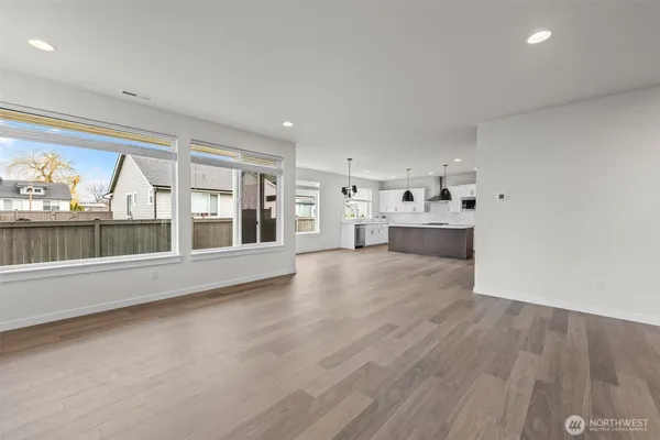 a view of empty room with wooden floor and fireplace