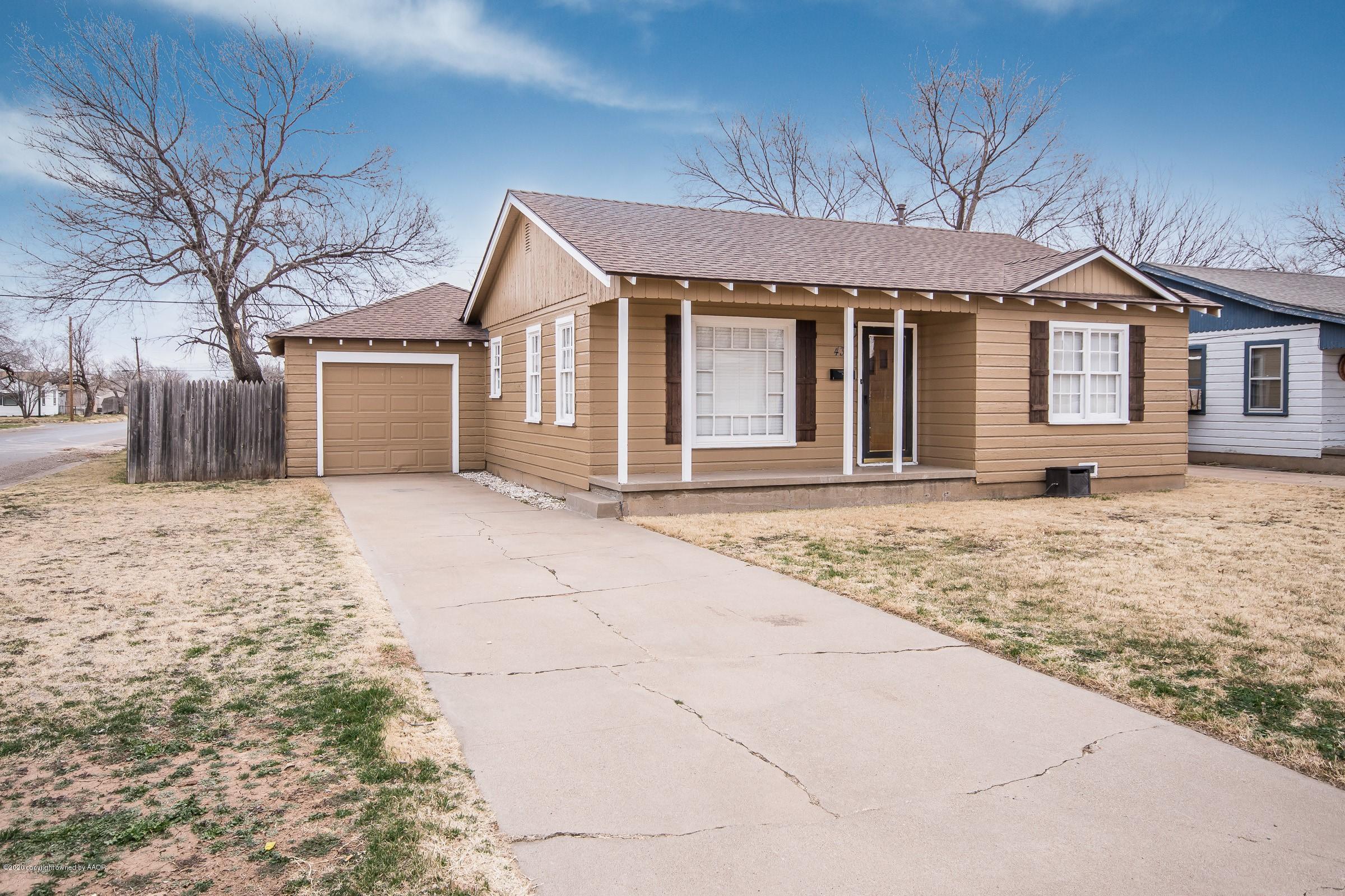 4301 South Jackson Street Amarillo, TX 79110 - Photo 1 of 18 a front view of a house with a yard and garage