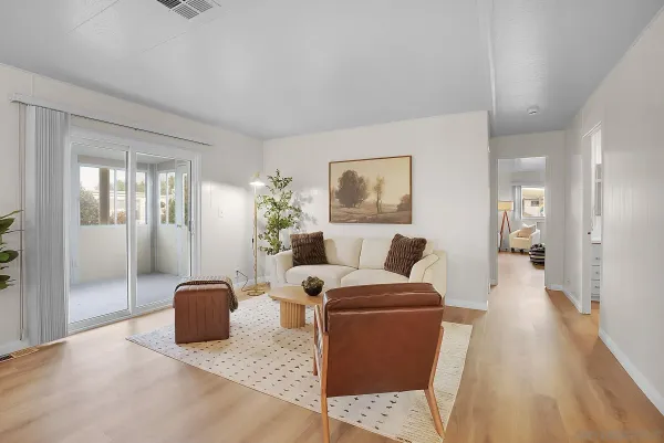 a living room with furniture and a potted plant