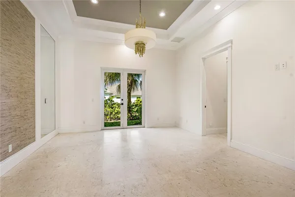 an empty room with fan and entrance