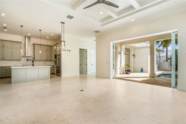 a large white kitchen with a sink and cabinets