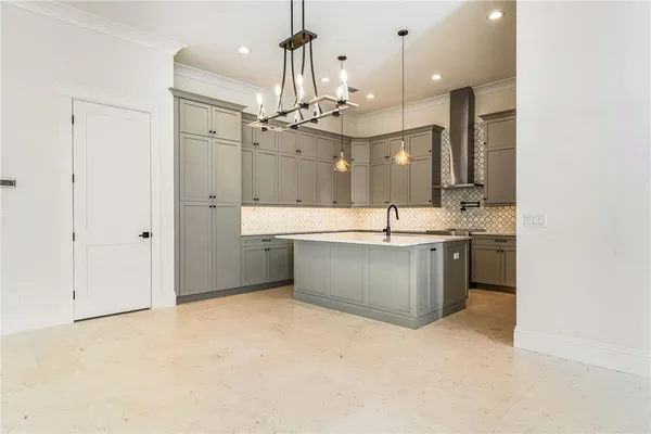 a large kitchen with a sink and cabinets