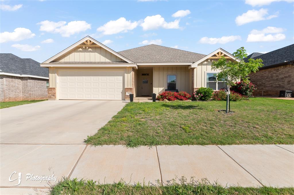 a front view of a house with a garden and plants