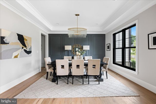 a living room with furniture a fireplace and a large window