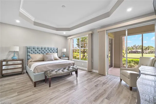 a spacious bedroom with a bed and large windows