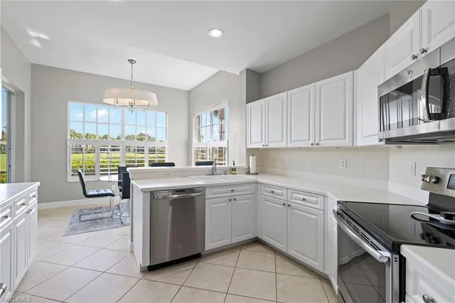 a kitchen with a sink window and cabinets