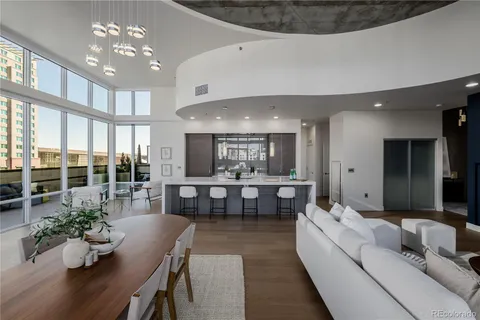 a living room with furniture kitchen and a chandelier