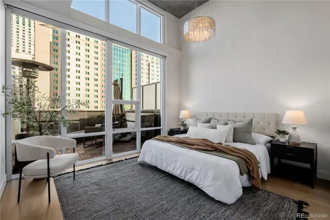 a bedroom with a bed and a lamp