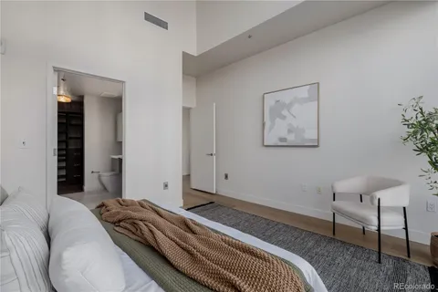 a bedroom with a large bed and a flat screen tv