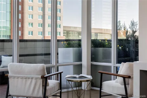 a balcony view with a large window and wooden floor