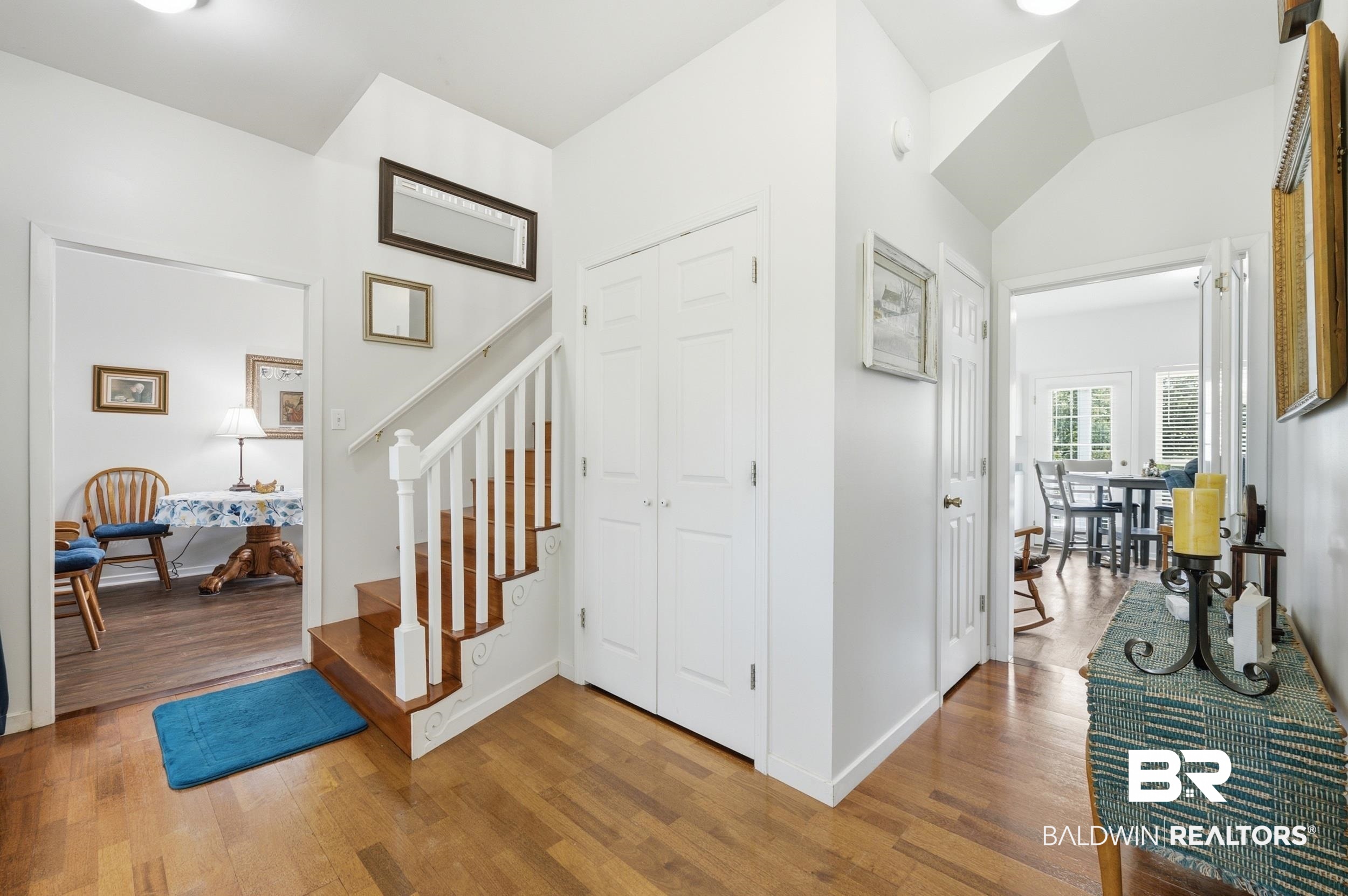 15855 Calvin Richerson Road Bay Minette, AL 36507 - Photo 37 of 83 Entryway featuring wood-finish flooring, a staircase with white balusters and wood treads, and white paneled doors