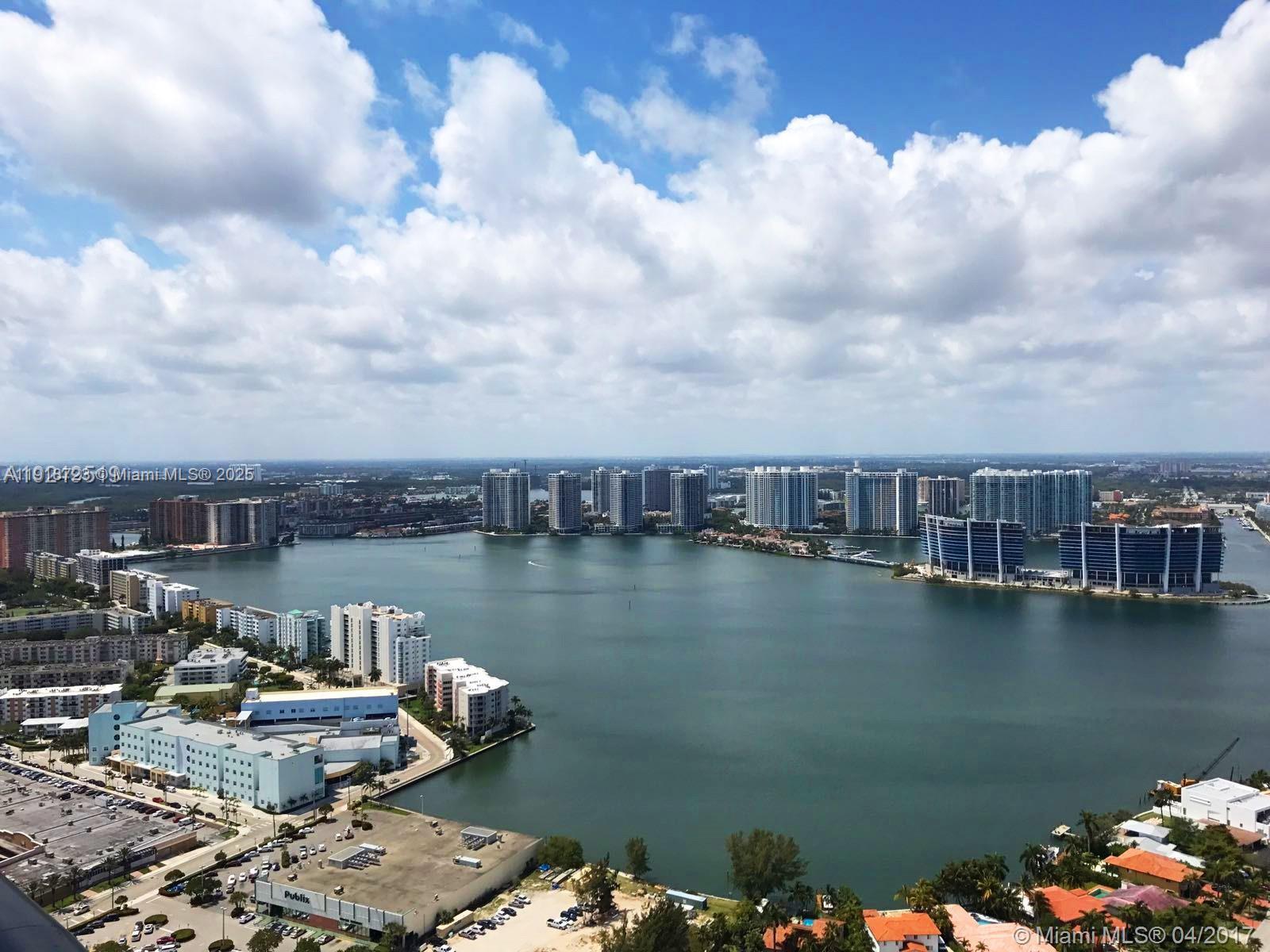 18555 Collins Avenue, Unit 4804 Sunny Isles Beach, FL 33160 - Photo 28 of 51 a view of a lake and a mountain view