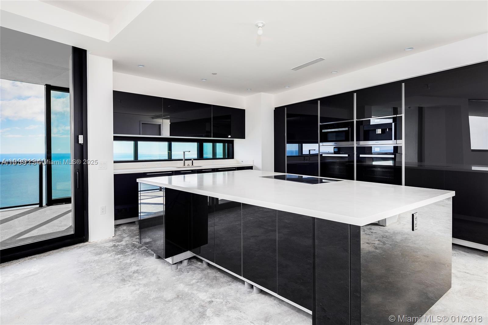 18555 Collins Avenue, Unit 4804 Sunny Isles Beach, FL 33160 - Photo 33 of 51 a living room with table