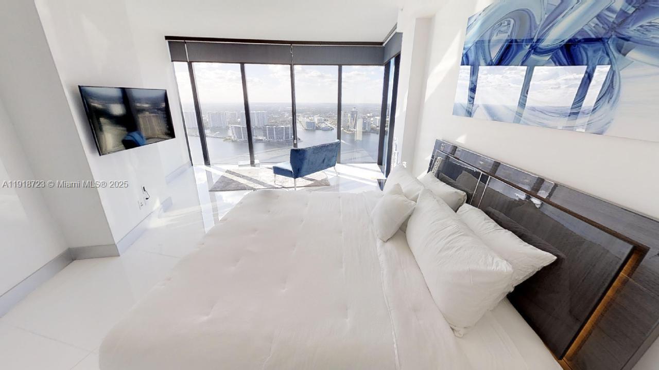 18555 Collins Avenue, Unit 4804 Sunny Isles Beach, FL 33160 - Photo 38 of 51 a view of a living room with furniture and a floor to ceiling window