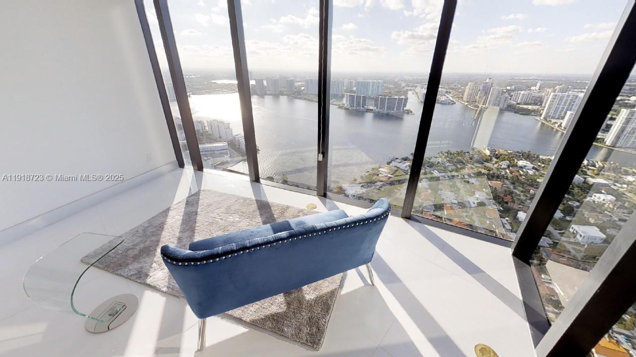 18555 Collins Avenue, Unit 4804 Sunny Isles Beach, FL 33160 - Photo 40 of 51 a view of living room with a floor to ceiling window