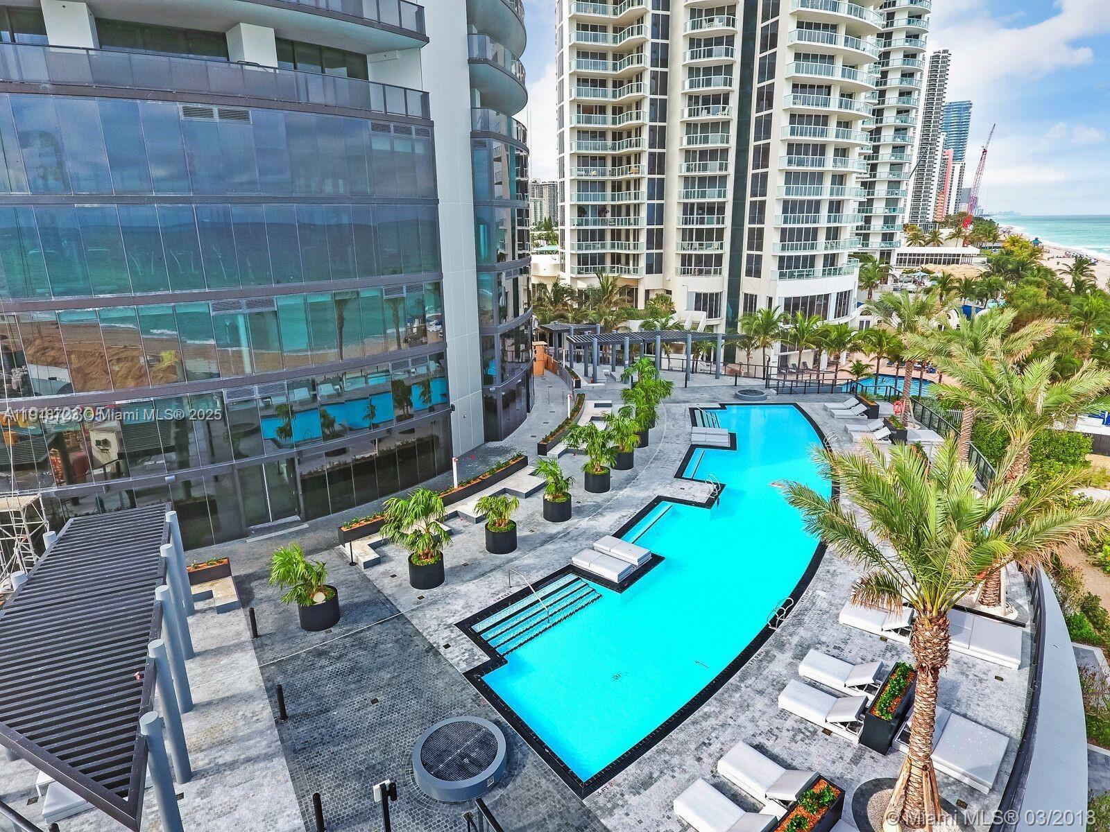 18555 Collins Avenue, Unit 4804 Sunny Isles Beach, FL 33160 - Photo 6 of 51 a view of a balcony with chairs and potted plants