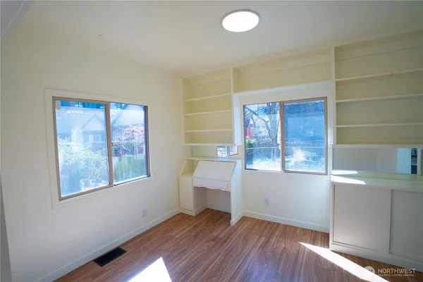 wooden floor in an empty room with a window