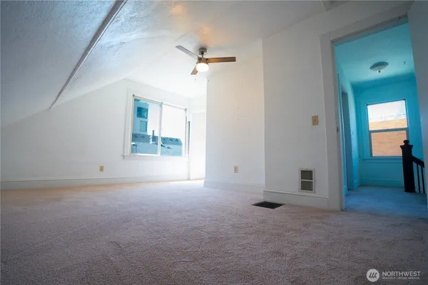 an empty room with windows and closet