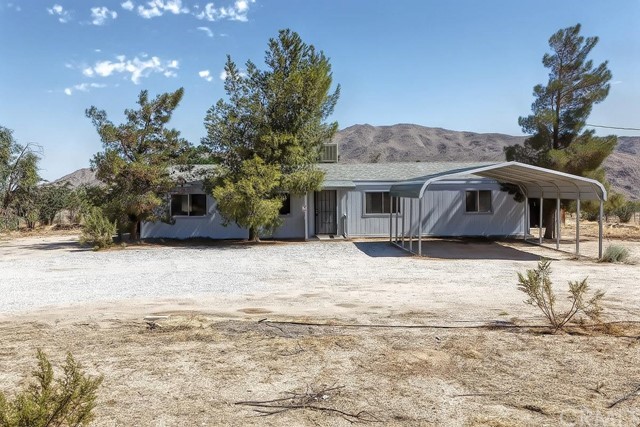 27082 Desert View Road Apple Valley, CA 92308 - Photo 1 of 1 a front view of a house with a yard and garage