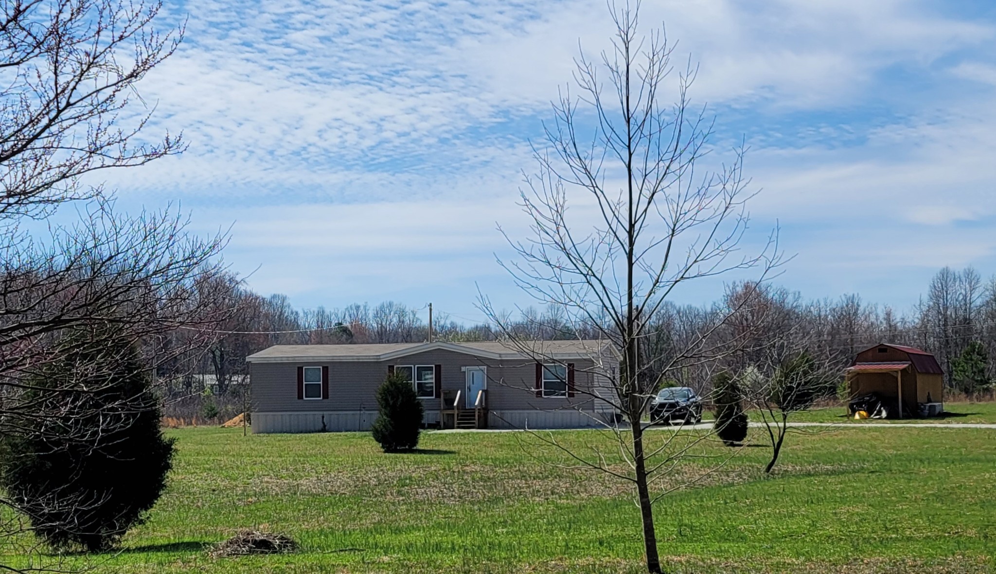 a front view of house with yard and green space