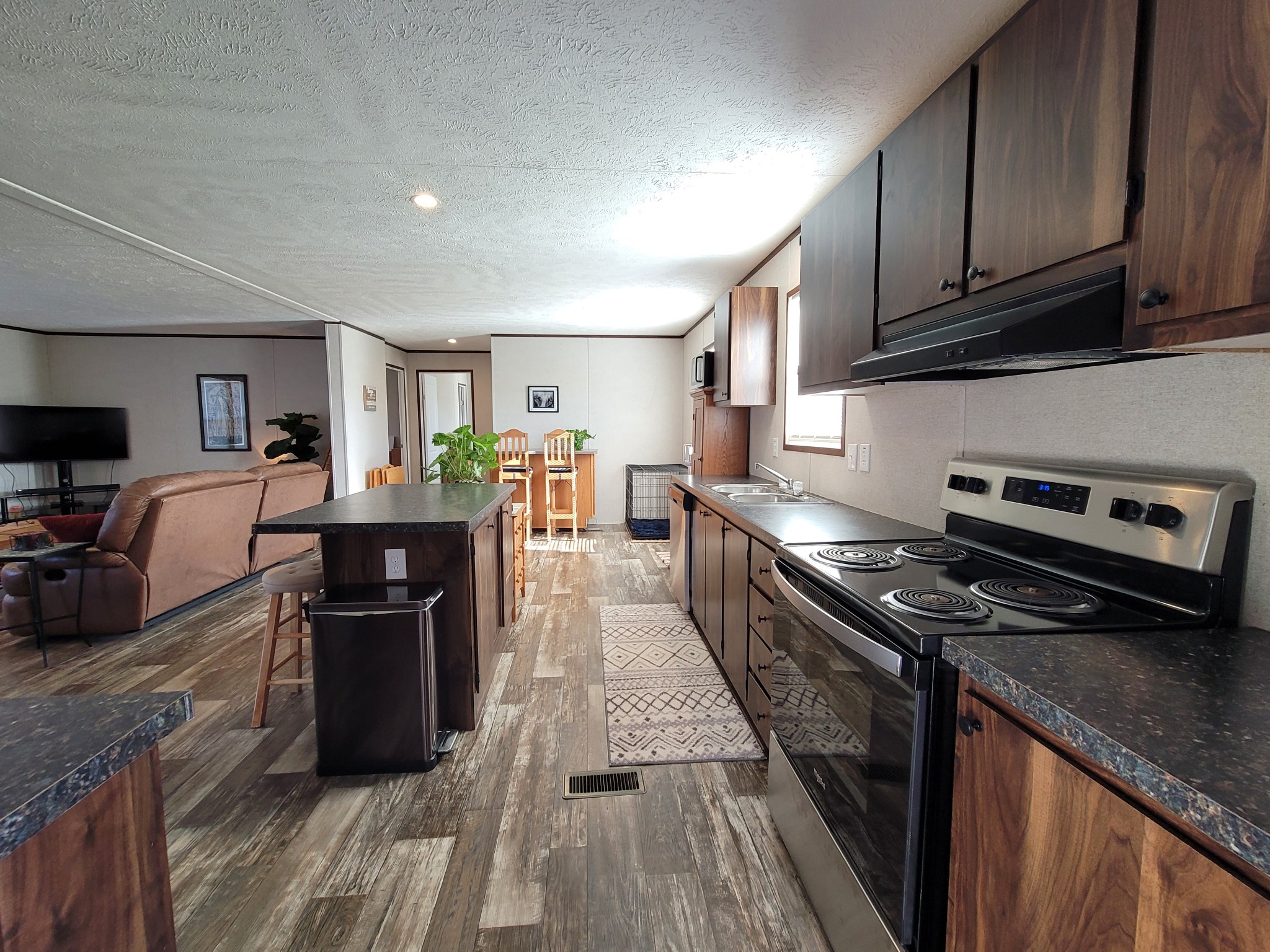 590 Jump Off Mountain Road Sewanee, TN 37375 - Photo 11 of 22 a kitchen with stainless steel appliances granite countertop a stove top oven a sink dishwasher and a refrigerator