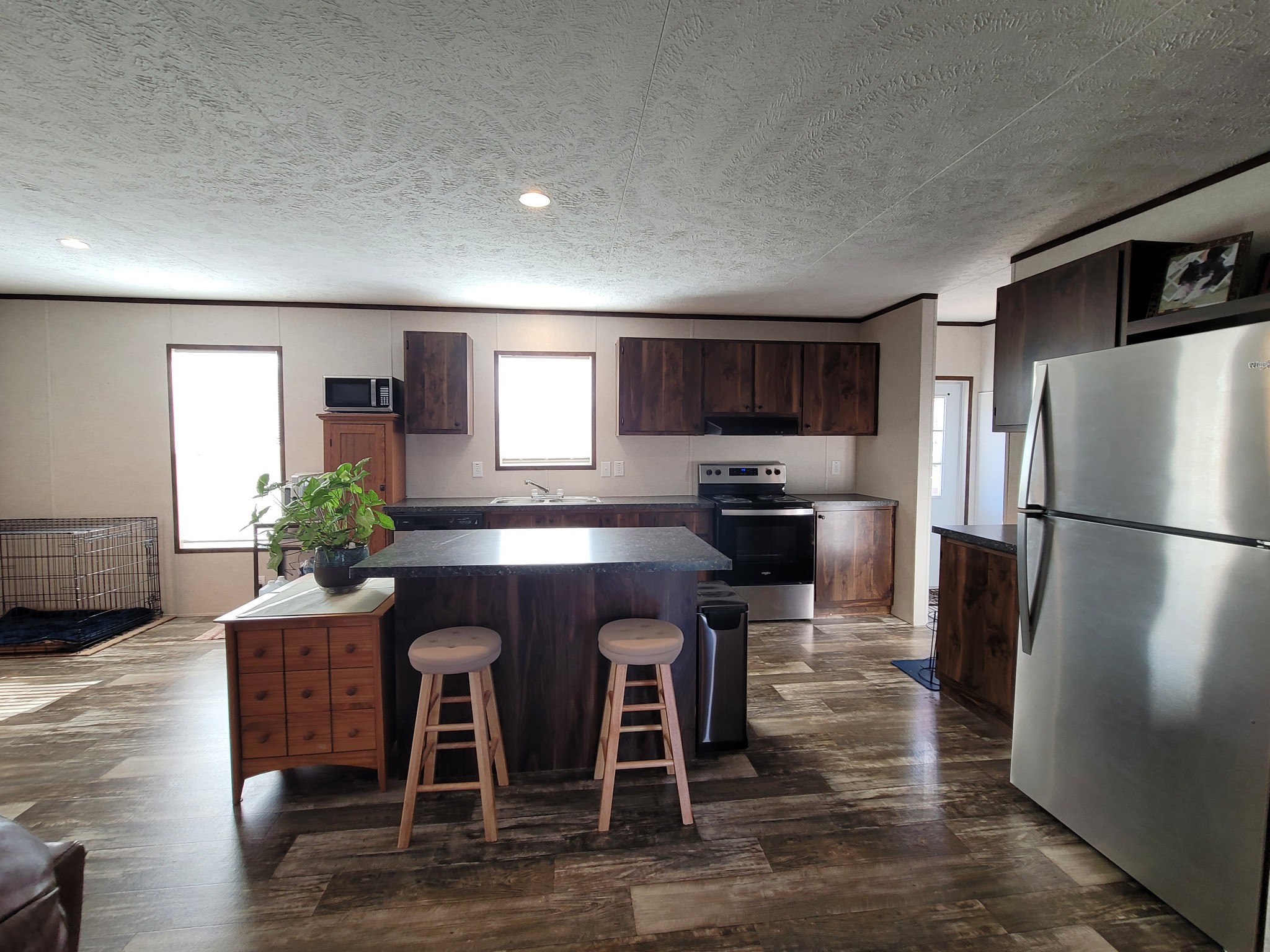 590 Jump Off Mountain Road Sewanee, TN 37375 - Photo 10 of 22 a kitchen with granite countertop a refrigerator stove microwave and cabinets with wooden floor