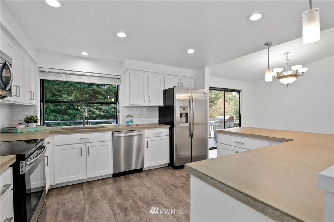 15504 Southeast 178th Place Renton, WA 98058 - Photo 12 of 40 a kitchen with refrigerator and window