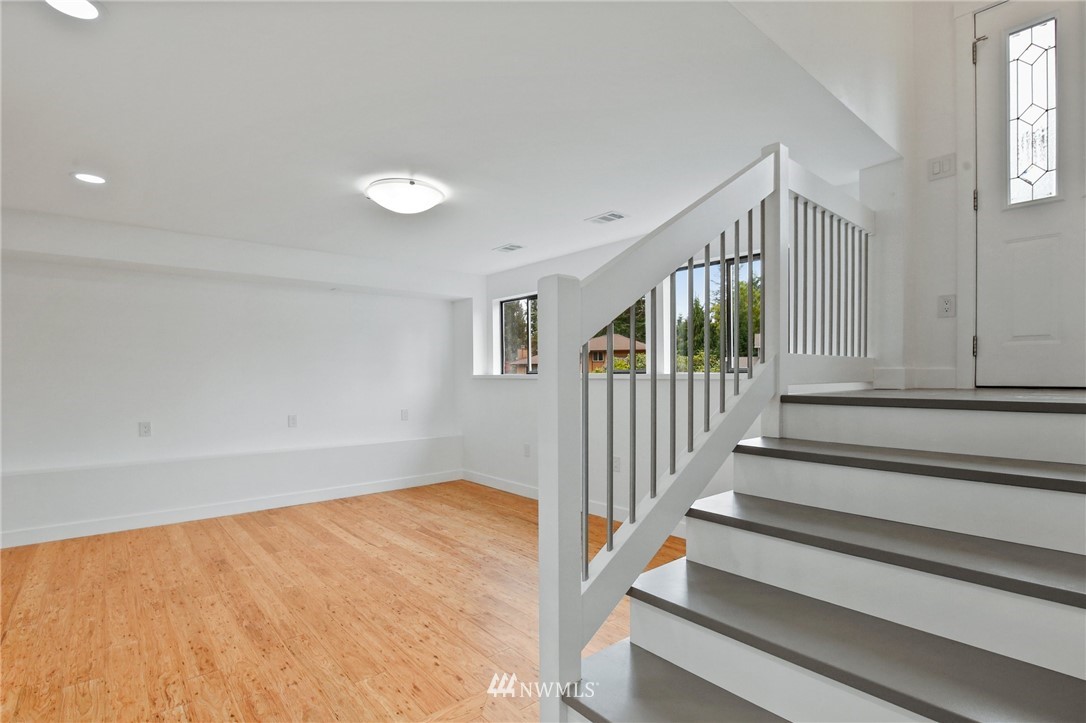 15504 Southeast 178th Place Renton, WA 98058 - Photo 26 of 40 a view of staircase with lots of frames on wall and a window