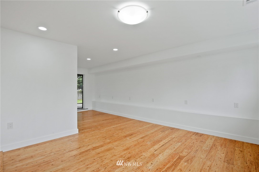 15504 Southeast 178th Place Renton, WA 98058 - Photo 28 of 40 a view of an empty room with wooden floor and a window