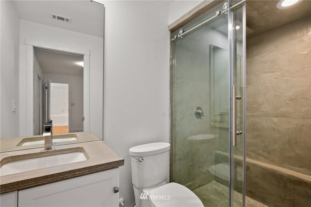 15504 Southeast 178th Place Renton, WA 98058 - Photo 30 of 40 a bathroom with a granite countertop sink toilet and shower