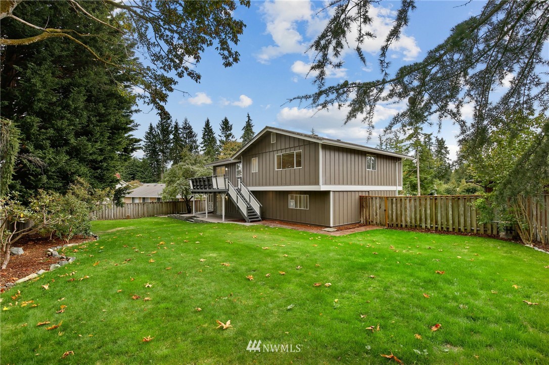 15504 Southeast 178th Place Renton, WA 98058 - Photo 36 of 40 a view of a house with a yard and trees
