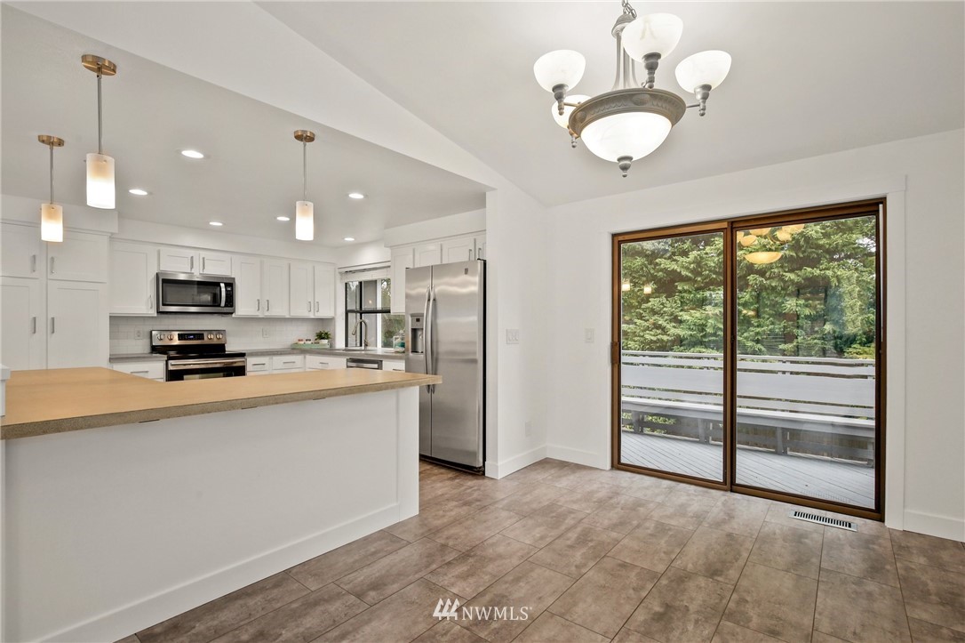 15504 Southeast 178th Place Renton, WA 98058 - Photo 6 of 40 a view of kitchen with stainless steel appliances granite countertop sink and microwave