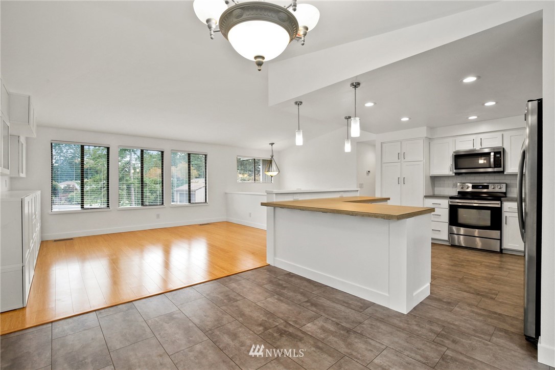 15504 Southeast 178th Place Renton, WA 98058 - Photo 8 of 40 a large kitchen with kitchen island a island in it