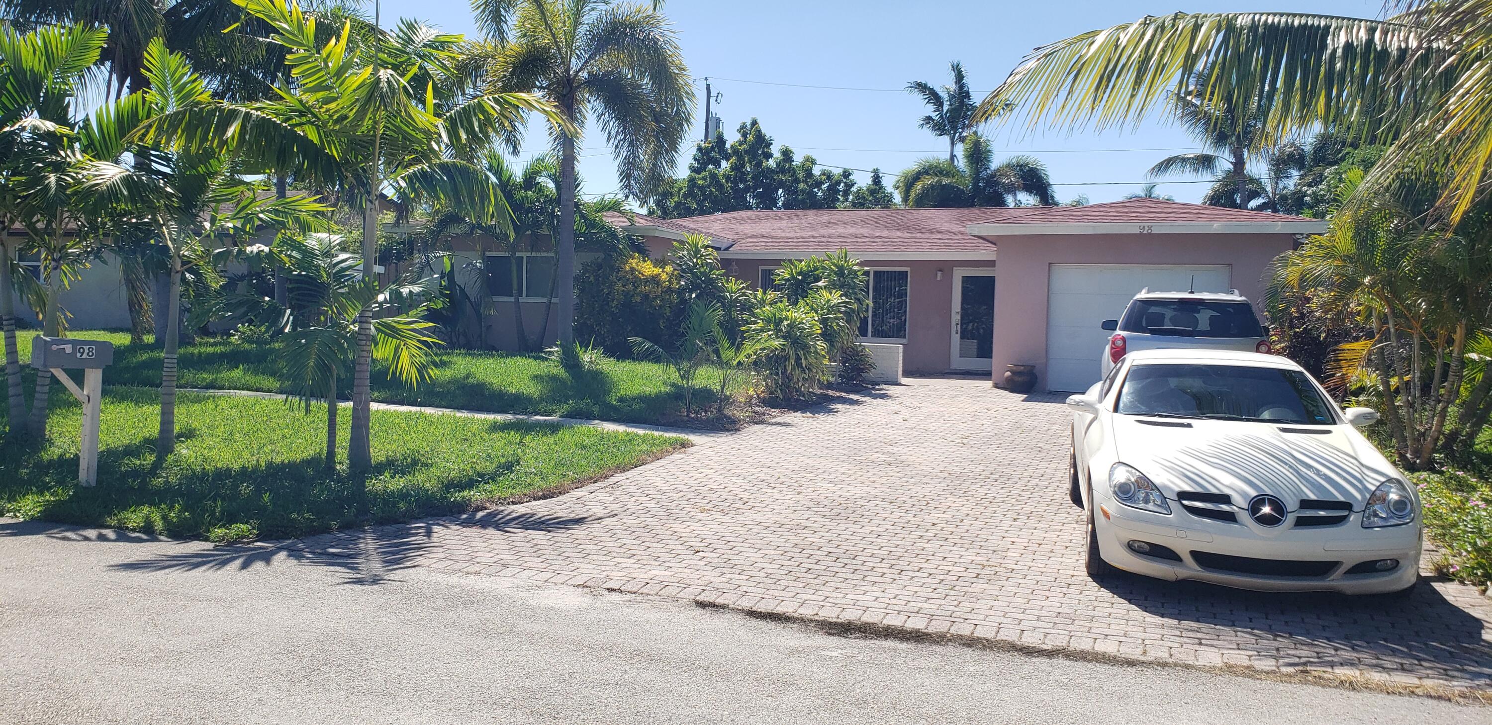 98 Seminole Lane Boca Raton, FL 33487 - Photo 23 of 42 a front view of a house with garden