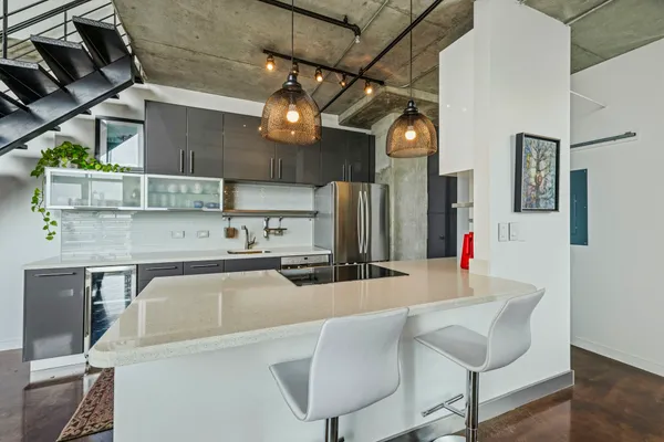 a kitchen with stainless steel appliances granite countertop a refrigerator and stove