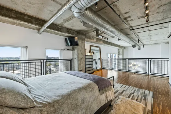 a bedroom with furniture and wooden floor