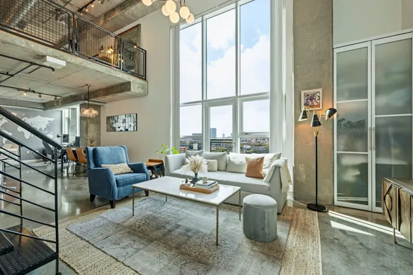 a living room with furniture and a potted plant