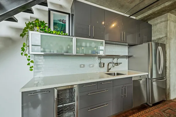 a living room with furniture a fireplace and a chandelier