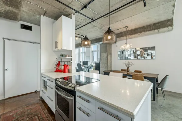 a kitchen with stainless steel appliances granite countertop a sink and a refrigerator