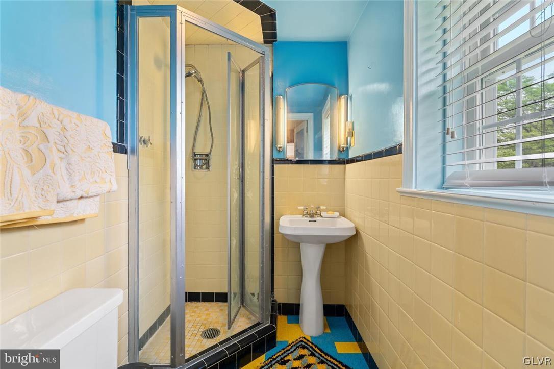 5081 Oley Turnpike Road Reading, PA 19606 - Photo 23 of 44 a bathroom with a sink a mirror and shower