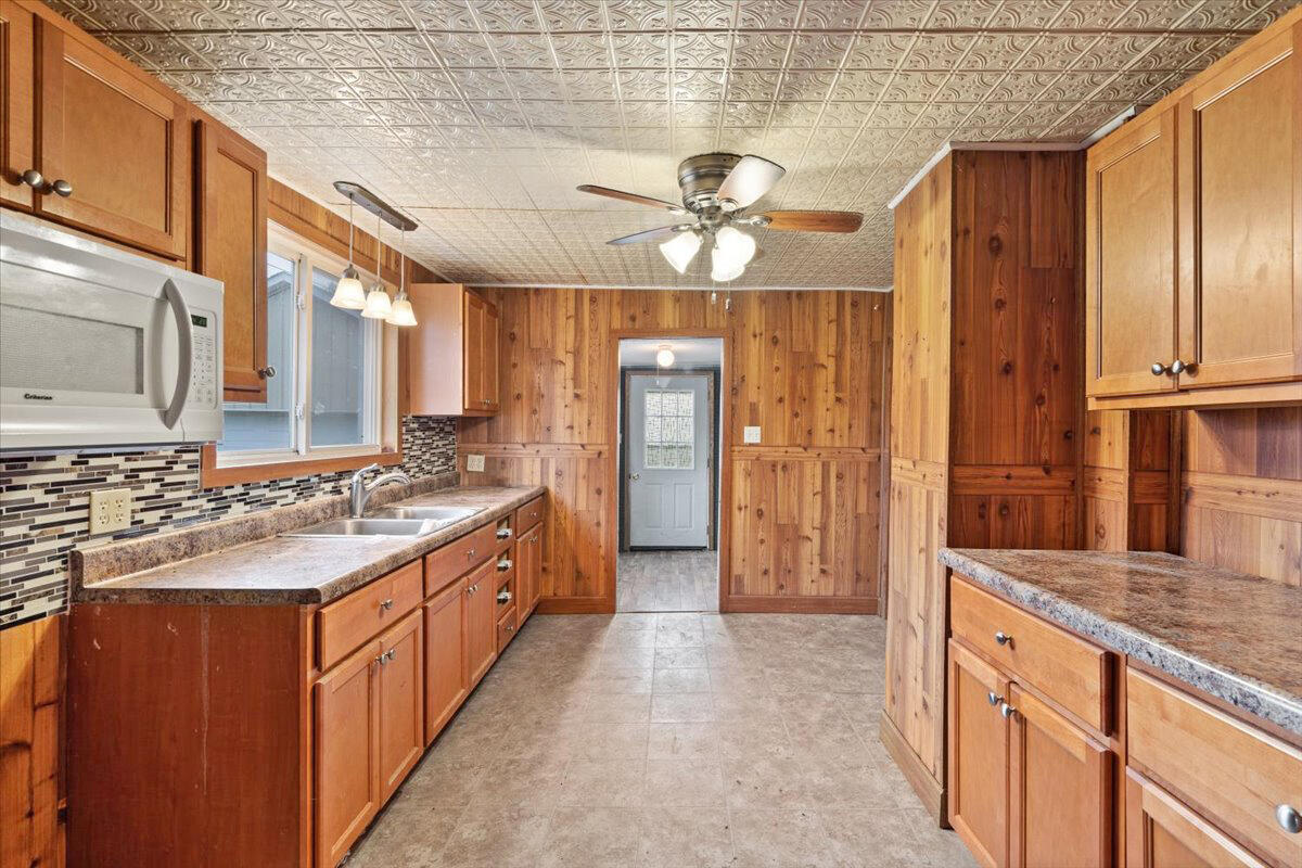 206 South Main Street Morocco, IN 47963 - Photo 11 of 26 a large kitchen with a stove a sink dishwasher a refrigerator and wooden cabinets