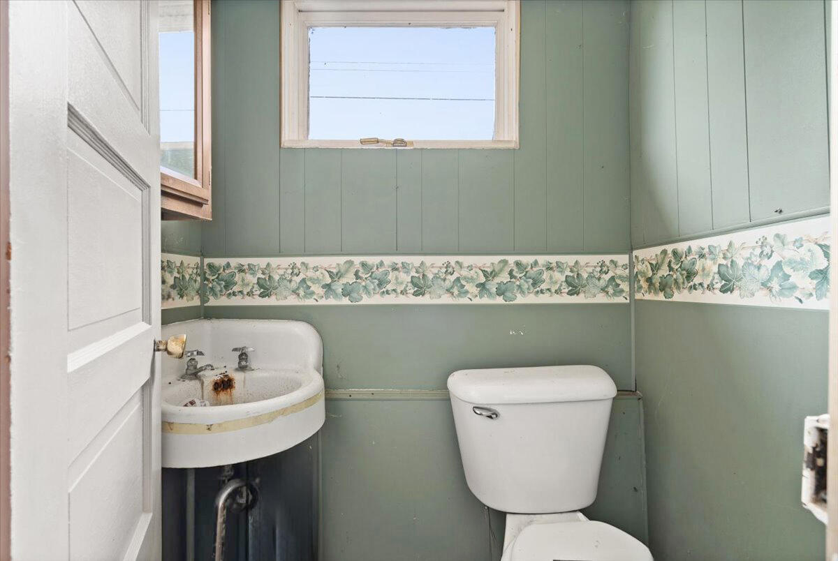 206 South Main Street Morocco, IN 47963 - Photo 12 of 26 a bathroom with a toilet a sink and a mirror