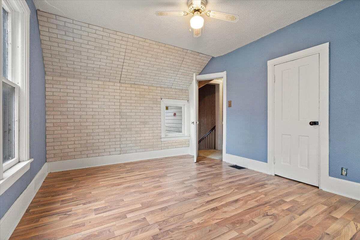 206 South Main Street Morocco, IN 47963 - Photo 19 of 26 a view of an empty room with wooden floor and a window