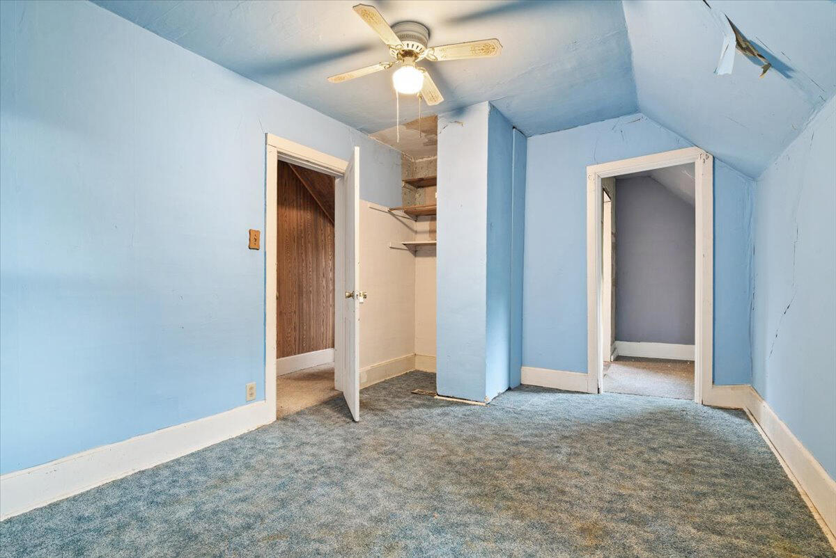 206 South Main Street Morocco, IN 47963 - Photo 21 of 26 an empty room with closet and a ceiling fan