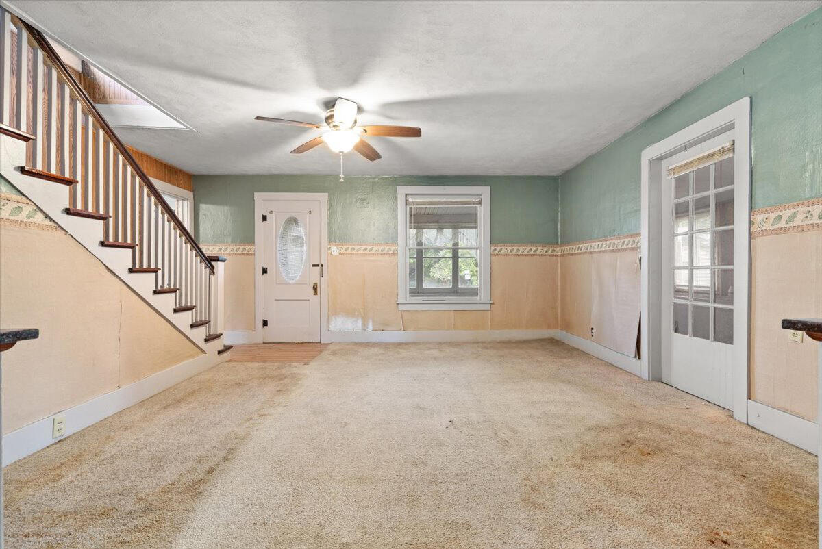 206 South Main Street Morocco, IN 47963 - Photo 6 of 26 an empty room with windows and fan