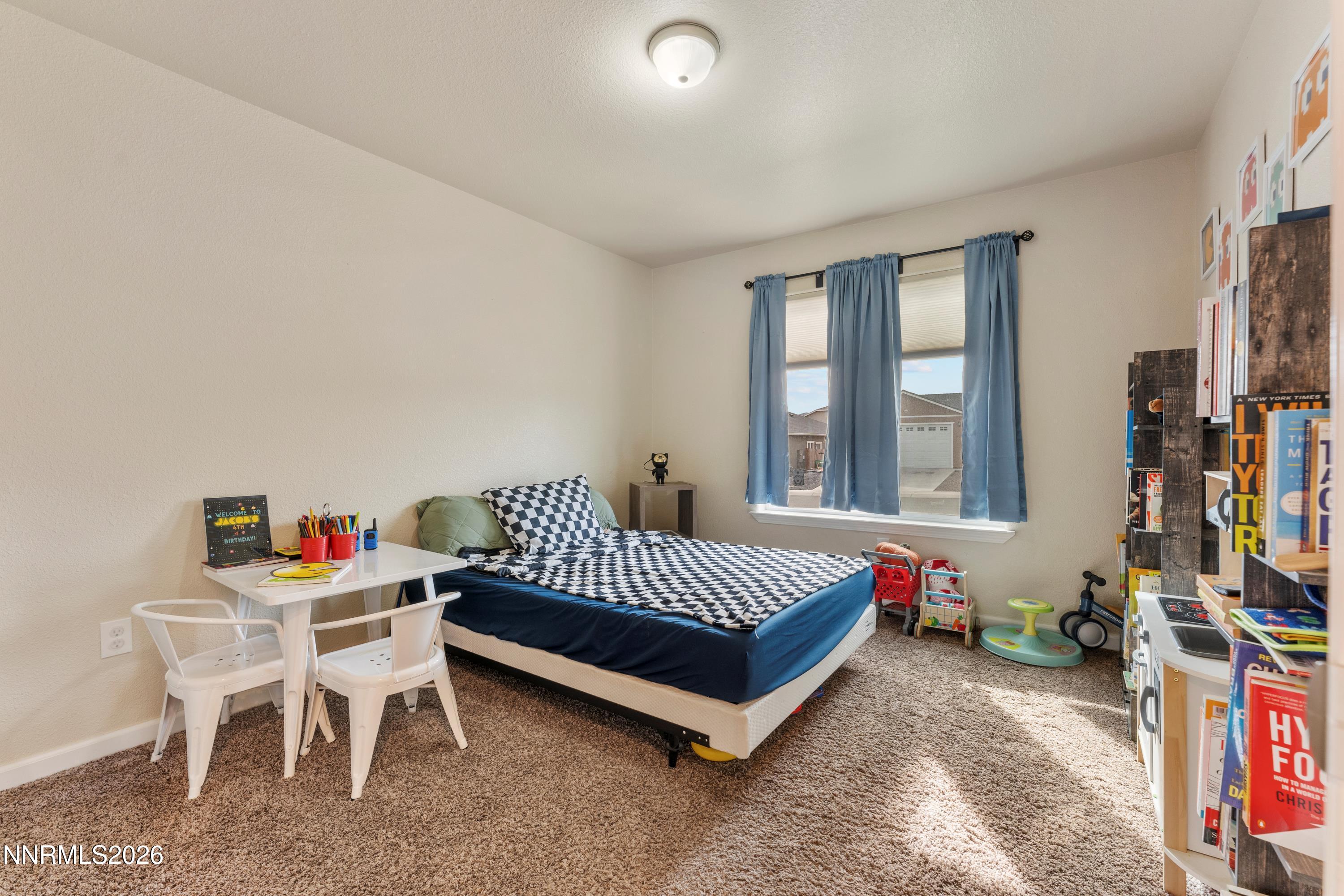 4540 Rutledge Street Fernley, NV 89408 - Photo 11 of 16 a bed room with a bed and a chair