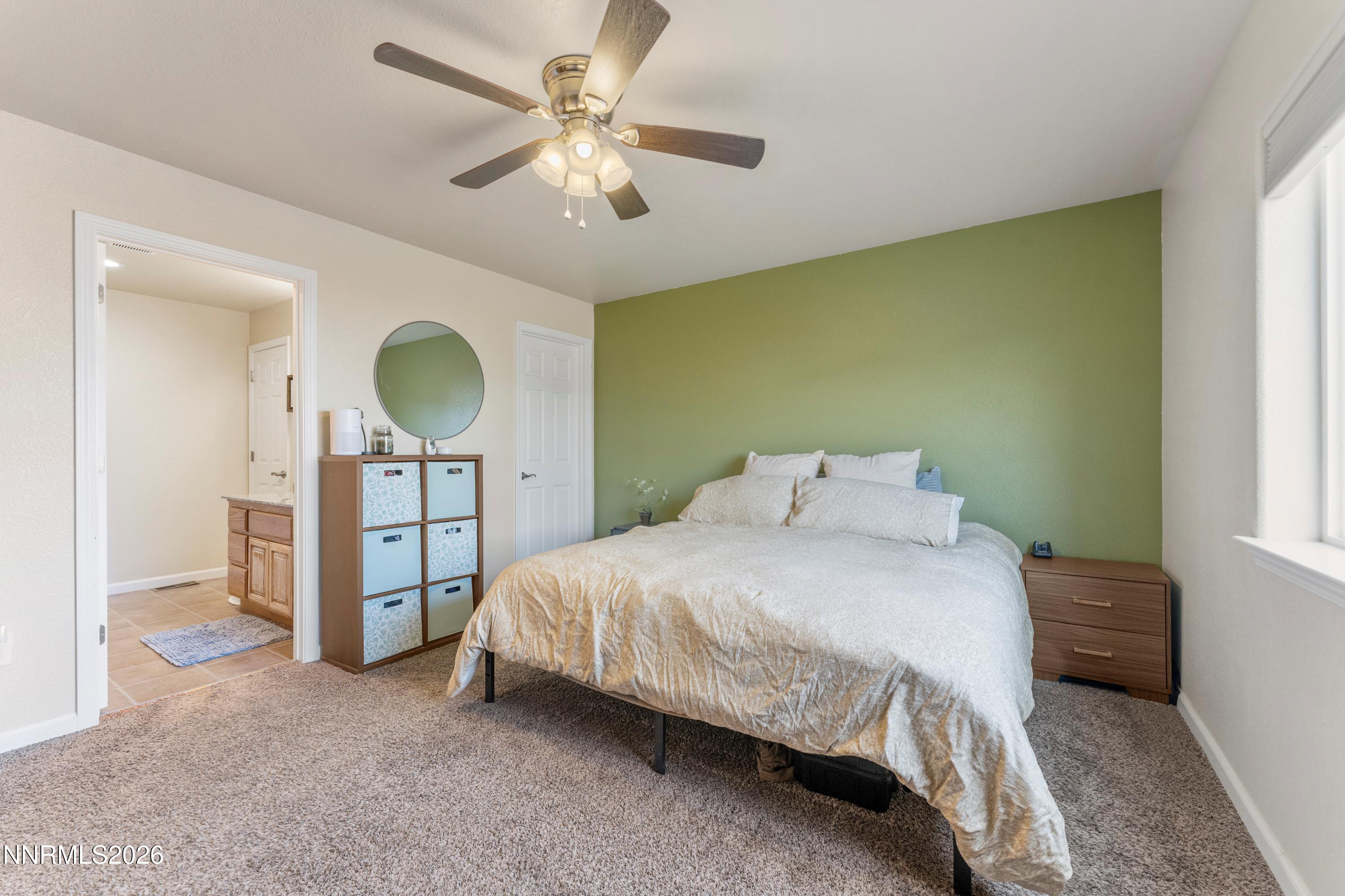 4540 Rutledge Street Fernley, NV 89408 - Photo 9 of 16 a bedroom with a bed and a chandelier