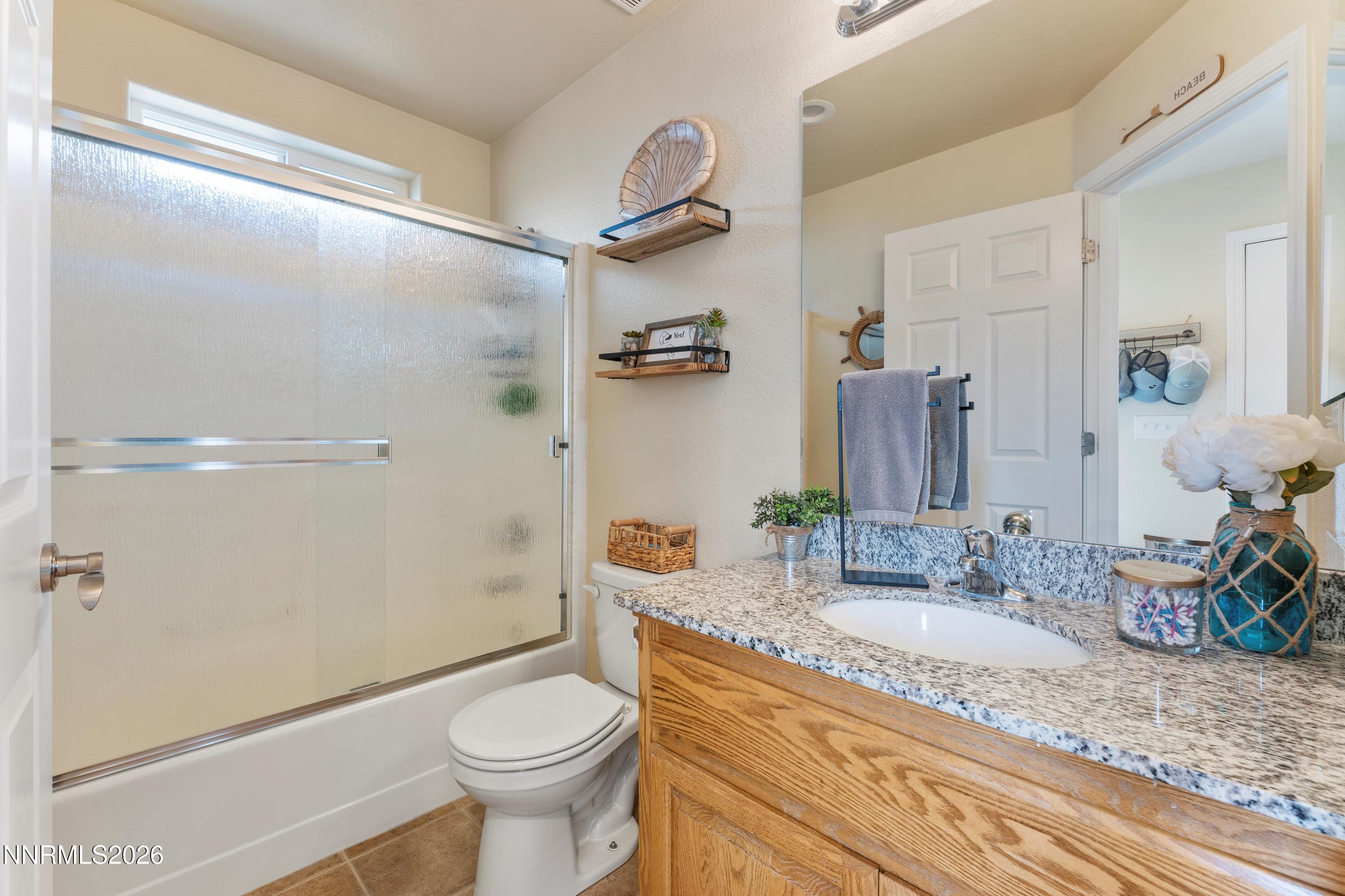 4540 Rutledge Street Fernley, NV 89408 - Photo 10 of 16 a bathroom with a granite countertop sink toilet and shower